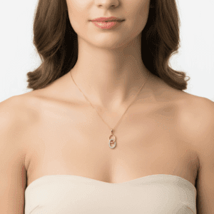 Złota zawieszka w kształcie owalu z cyrkoniami na modelce